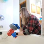 PowerPuff Plumbing fixing clogged drain in the bathroom in Puyallup, WA